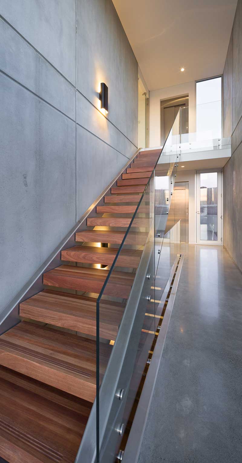 View of internal stair with feature jarrah treads and glass balustrade